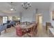 Open-concept dining room with a large wooden table, chandelier, and ample seating at 6503 E Walton Dr, Camby, IN 46113