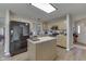 Well-lit kitchen featuring stainless steel appliances, a kitchen island, and a stylish subway tile backsplash at 6503 E Walton Dr, Camby, IN 46113