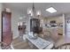 Open-concept living space with hardwood floors, dining area, fireplace, and natural lighting at 6503 E Walton Dr, Camby, IN 46113