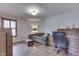 Office space featuring a sofa, desk, and natural light from the window with shutters at 6503 E Walton Dr, Camby, IN 46113