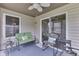 Covered patio with a ceiling fan, comfortable seating, and sliding door access to the home at 6503 E Walton Dr, Camby, IN 46113