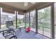 Inviting screened-in porch with comfortable seating and views of the landscaped backyard at 6503 E Walton Dr, Camby, IN 46113