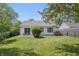 Well-maintained backyard with lush green grass, patio area, and a white home exterior at 6613 Apollo Way, Indianapolis, IN 46278