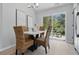 Cozy dining area with modern lighting and sliding glass doors to the backyard, adjacent to kitchen at 6613 Apollo Way, Indianapolis, IN 46278