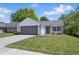 Charming single-story home with a well-manicured lawn, gray garage door, and white siding at 6613 Apollo Way, Indianapolis, IN 46278
