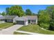 Charming single-story home with a well-manicured lawn and an attached two-car garage at 6613 Apollo Way, Indianapolis, IN 46278