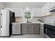 Updated kitchen with white cabinetry, stainless steel appliances, and marble countertops for a sleek design at 6613 Apollo Way, Indianapolis, IN 46278