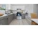 Well-lit kitchen with stainless steel appliances, two tone cabinets, and ample counter space at 6613 Apollo Way, Indianapolis, IN 46278