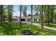 Aerial view of a charming home with a well-kept lawn, surrounded by mature trees, and an American flag at 6673 Karyn Dr, Avon, IN 46123