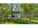 Aerial view of a charming home with a well-kept lawn, surrounded by mature trees at 6673 Karyn Dr, Avon, IN 46123