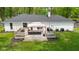 Back of house showing spacious deck with furniture, grill, and well-maintained yard at 6673 Karyn Dr, Avon, IN 46123
