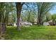 Well-manicured backyard with green grass and a deck at 6673 Karyn Dr, Avon, IN 46123