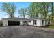 Charming single-story home with a black two-car garage, a landscaped yard, and driveway at 6673 Karyn Dr, Avon, IN 46123