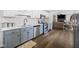 Modern kitchen with stainless steel appliances, two-tone cabinets, and an open layout to the living room at 6673 Karyn Dr, Avon, IN 46123