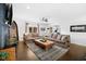 Comfortable living room featuring hardwood floors and neutral tones, open to the kitchen at 6673 Karyn Dr, Avon, IN 46123