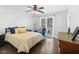 Bright main bedroom features large window, hardwood floors, and modern ceiling fan at 6673 Karyn Dr, Avon, IN 46123