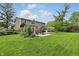 Expansive backyard with a well-manicured lawn, pergola, and patio area, perfect for outdoor entertaining and relaxation at 6825 Farmleigh Dr, Indianapolis, IN 46220