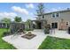 Charming backyard with a fire pit, pergola, grill, mature trees, and well-maintained lawn, creating a cozy outdoor living space at 6825 Farmleigh Dr, Indianapolis, IN 46220