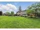 Spacious backyard with lush green grass, mature trees, and a well-maintained lawn, perfect for outdoor activities and relaxation at 6825 Farmleigh Dr, Indianapolis, IN 46220