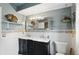 Well-lit bathroom with a double sink vanity, decorative mirror, and modern fixtures at 6825 Farmleigh Dr, Indianapolis, IN 46220