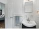 Bright bathroom featuring a sink, towel rack, mirror, with access to the bedroom at 6825 Farmleigh Dr, Indianapolis, IN 46220