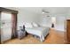 Bright bedroom featuring hardwood floors, ceiling fan with an ensuite bathroom at 6825 Farmleigh Dr, Indianapolis, IN 46220