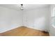 Spacious bedroom with hardwood floors and a large window at 6825 Farmleigh Dr, Indianapolis, IN 46220
