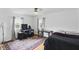 Bedroom with a ceiling fan, two windows, and hardwood floors at 6825 Farmleigh Dr, Indianapolis, IN 46220