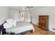 Bright bedroom featuring hardwood floors, ceiling fan with access to an ensuite bathroom at 6825 Farmleigh Dr, Indianapolis, IN 46220