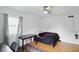 Bedroom featuring a desk, ceiling fan, window, and hardwood floors at 6825 Farmleigh Dr, Indianapolis, IN 46220