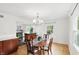 Open dining room with hardwood floors, a chandelier, and natural light that creates a welcoming atmosphere at 6825 Farmleigh Dr, Indianapolis, IN 46220