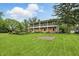 Charming two-story home boasting a brick and siding exterior, a manicured lawn, and double balconies at 6825 Farmleigh Dr, Indianapolis, IN 46220