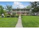 Traditional two-story home features a brick and siding facade, manicured landscaping, and inviting entryway at 6825 Farmleigh Dr, Indianapolis, IN 46220