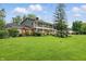Spacious two-story home features a balcony, beautiful landscaping, and a well-maintained lawn at 6825 Farmleigh Dr, Indianapolis, IN 46220