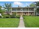 Charming two-story brick home with lush landscaping and a welcoming front porch at 6825 Farmleigh Dr, Indianapolis, IN 46220