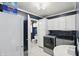 Functional laundry room with white cabinets, appliances, and view of a half bath at 6825 Farmleigh Dr, Indianapolis, IN 46220