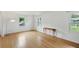 Hardwood floor living room with a table, a lamp, and bright windows providing natural light at 6825 Farmleigh Dr, Indianapolis, IN 46220