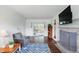 Spacious living room with fireplace, hardwood floors, and access to the outdoors at 6825 Farmleigh Dr, Indianapolis, IN 46220