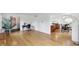 Spacious open-concept living room with hardwood floors adjacent to a dining area and staircase at 6825 Farmleigh Dr, Indianapolis, IN 46220