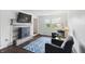 Comfortable living room with fireplace, hardwood floors, and abundant natural light at 6825 Farmleigh Dr, Indianapolis, IN 46220