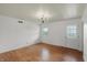 Bright living room with hardwood floors, white walls, and a classic chandelier at 6825 Farmleigh Dr, Indianapolis, IN 46220