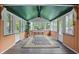 Charming sunroom with ample windows, ceiling fan, and classic area rug at 6825 Farmleigh Dr, Indianapolis, IN 46220