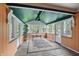 Bright sunroom with multiple windows, ceiling fan, and a beautiful area rug at 6825 Farmleigh Dr, Indianapolis, IN 46220
