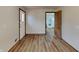 Open living room with wood-look flooring flowing into the kitchen at 6985 E County 100 S Rd, Avon, IN 46123