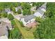 Aerial view of a home's backyard featuring a wooden deck, mature trees, and a well-maintained lawn at 7388 Wythe Dr, Noblesville, IN 46062