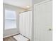 Bathroom featuring wood-look flooring, white door, and a white shower curtain at 7388 Wythe Dr, Noblesville, IN 46062