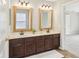 Bathroom featuring double sinks, wooden cabinets, and large framed mirrors at 7388 Wythe Dr, Noblesville, IN 46062