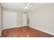 A bedroom with hardwood floors, a ceiling fan, and a closet with sliding doors at 7388 Wythe Dr, Noblesville, IN 46062