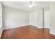 Large bedroom featuring wood floors, white walls, a fan, and a window at 7388 Wythe Dr, Noblesville, IN 46062