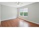 A sunlit bedroom with hardwood floors and a large, bright window at 7388 Wythe Dr, Noblesville, IN 46062